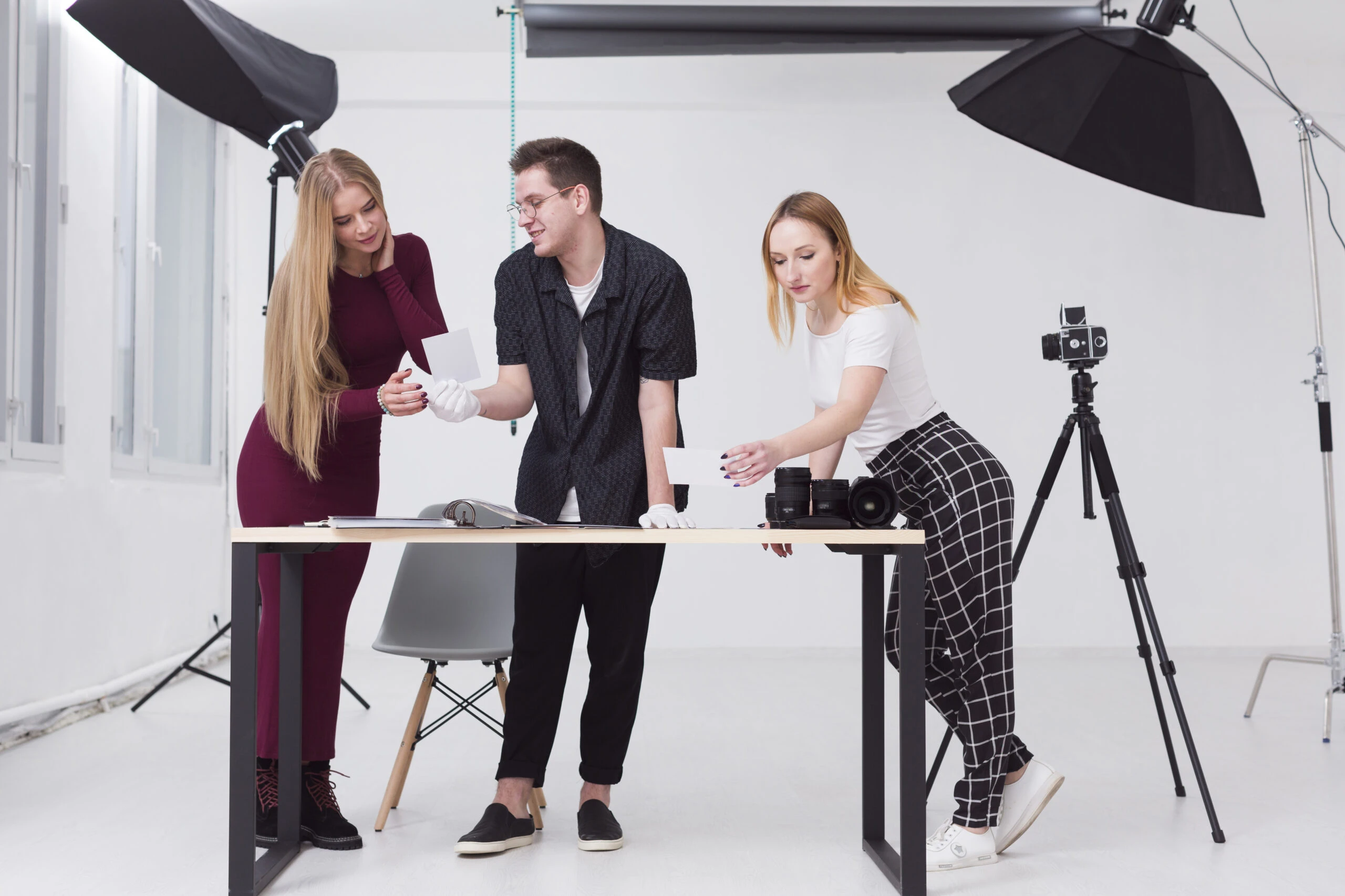 women-man-looking-through-photos-studio women-man-looking-through-photos-studio